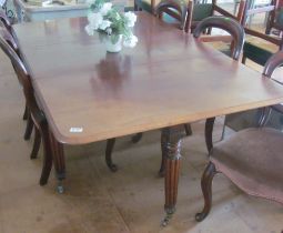 A mahogany drop flap table fluted legs