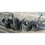 Four watering cans