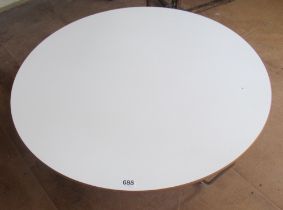 A low Senator white topped circular coffee table on chrome supports
