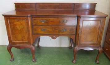 A walnut sideboard, two central drawers on shell capped cabriole legs on claw feet