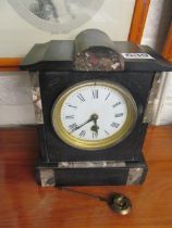 A Victorian black slate and marble mantle clock
