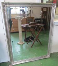 A very large rectangular bevelled edge mirror in silver coloured frame