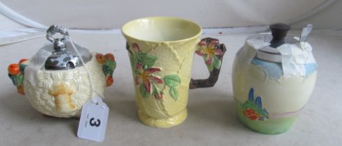 A Clarice Cliff Harvest sucrier, Falcon Ware preserve jar and Carlton Ware mug