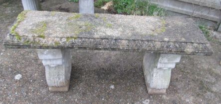 A concrete bench on twin supports