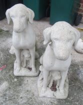 A pair of garden ornaments dogs with puppies