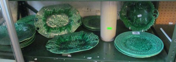 A group of Victorian green pottery plates and dishes and a stone flagon