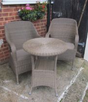 A cane conservatory table and two chairs