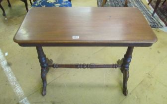 A Victorian mahogany stretcher table with turned rail and cabriole legs