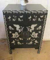 A black two door cabinet with two drawers decorated silver butterflies