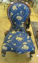 A Victorian walnut showframe ladies chair on carved cabriole supports (in need of re-upholstery)