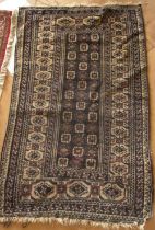 A beige, brown and dark blue geometric pattern rug