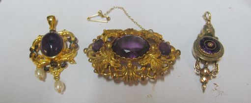 A brooch and two pendants