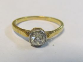 A solitaire diamond ring on gold band Size O