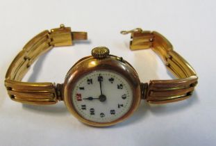 A 9ct gold ladies watch with 9ct gold strap