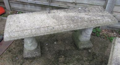 A concrete bench on twin supports