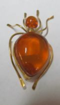 A Russian gold and amber colour brooch and 9ct gold enamel charm of church with Baptism inside