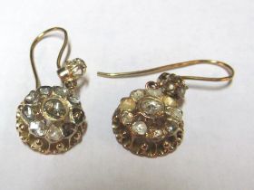 A pair gold and diamond earrings closed backs and rough cut