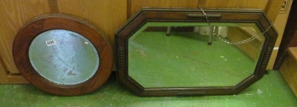 A 1920's oak framed wall mirror and an oak circular mirror