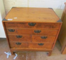 A small low chest of seven drawers