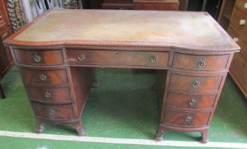 A twin pedestal desk with bowfronted pedestals