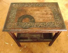 An oak occasional table and two matching low chairs carved dragon and snake design