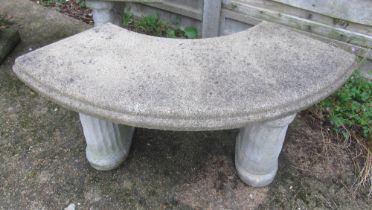 A curved concrete bench