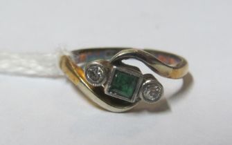 A gold and platinum emerald and diamond three stone ring