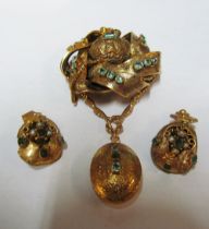 A gold coloured brooch with hair locket to back set green stones and a pair of earrings set green