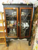 A mahogany blind fret cabinet on cabriole legs