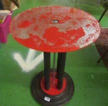 An Art Deco circular red and black occasional table with silver effect