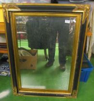 A gilt mirror and black frame mirror