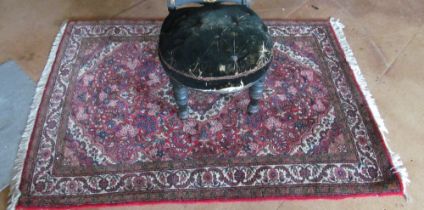 A pink and cream ground floral rug (edges worn)