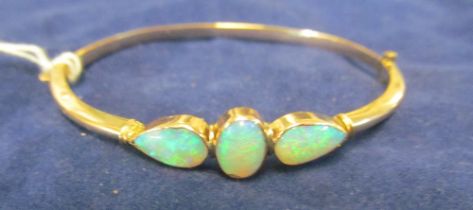 A 9ct gold bangle bracelet set three opals