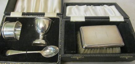 A brush with silver back and a Christening set