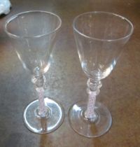 A set of six conical glasses with red and opaque twist stems