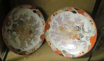 A pair of Japanese kutani large chargers decorated peacocks amongst flowers