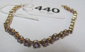 A yellow metal bracelet purple stones, marked 10k 5g