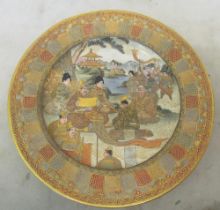 A 19th Century satsuma plate highly decorated with scenes of dignitaries and geisha in garden with