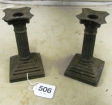 A pair of silver dwarf candlesticks