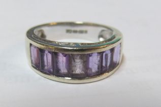 A 9ct gold ring set seven purple stones, centre stone chipped 3.6g