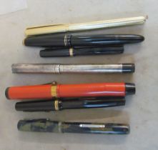 A collection of fountain pens pencils including silver example