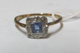 An 18ct gold square illusion set diamond and blue stone ring