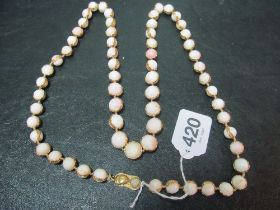 Some cream colour beads (coral?) with 18ct gold clasp