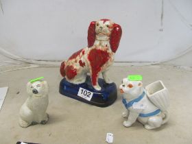 A Staffordshire Comforter dog (re-painted), a pug dog with basket on his back and a Staffordshire