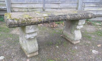 A concrete bench on twin supports