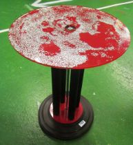 An Art Deco circular red and black occasional table with silver effect