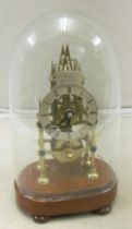A skeleton clock under glass dome