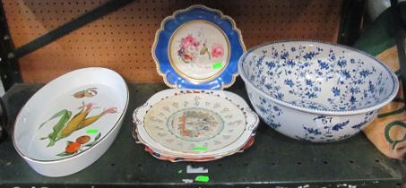 A blue and white circular bowl, some plates and an Evesham dish