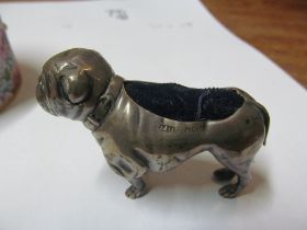 A silver Bulldog pin cushion