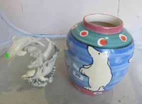 An Italian pottery vase decorated polar bears and a resin dolphin ornament